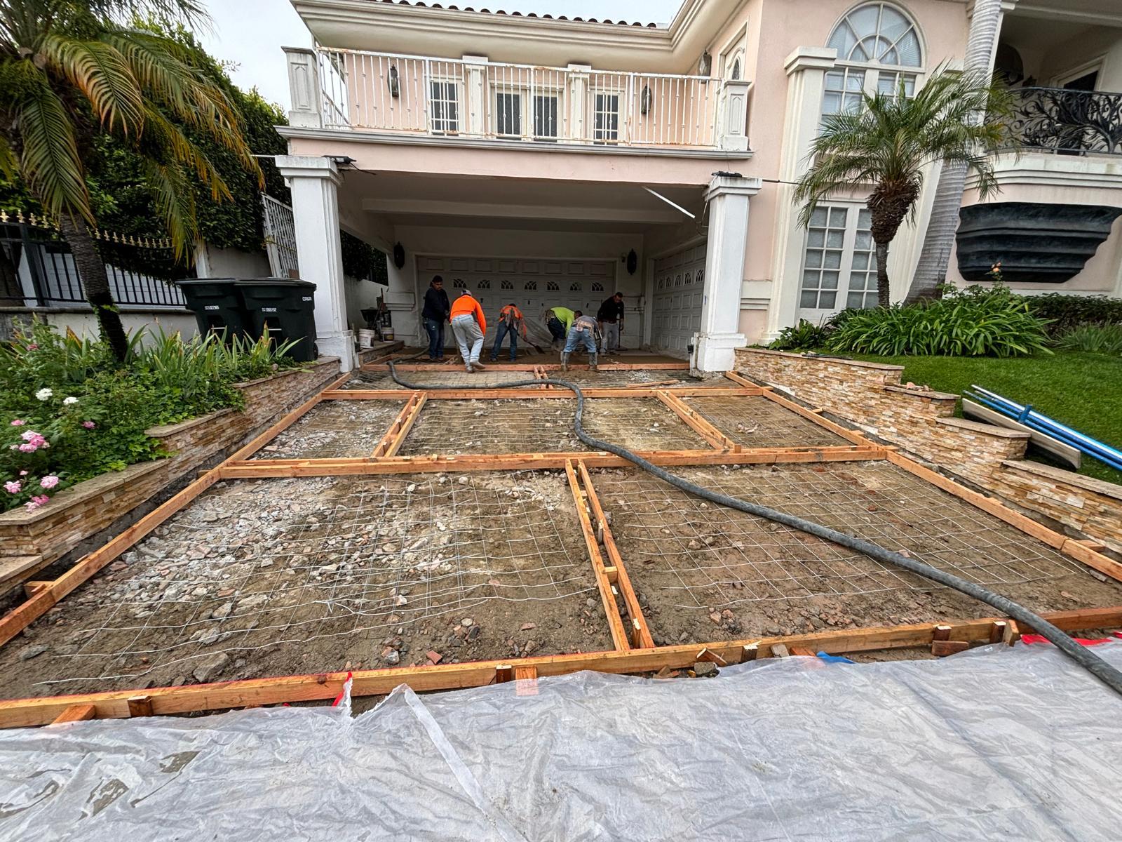 Crew setting forms and wire mesh reinforcement for driveway pour