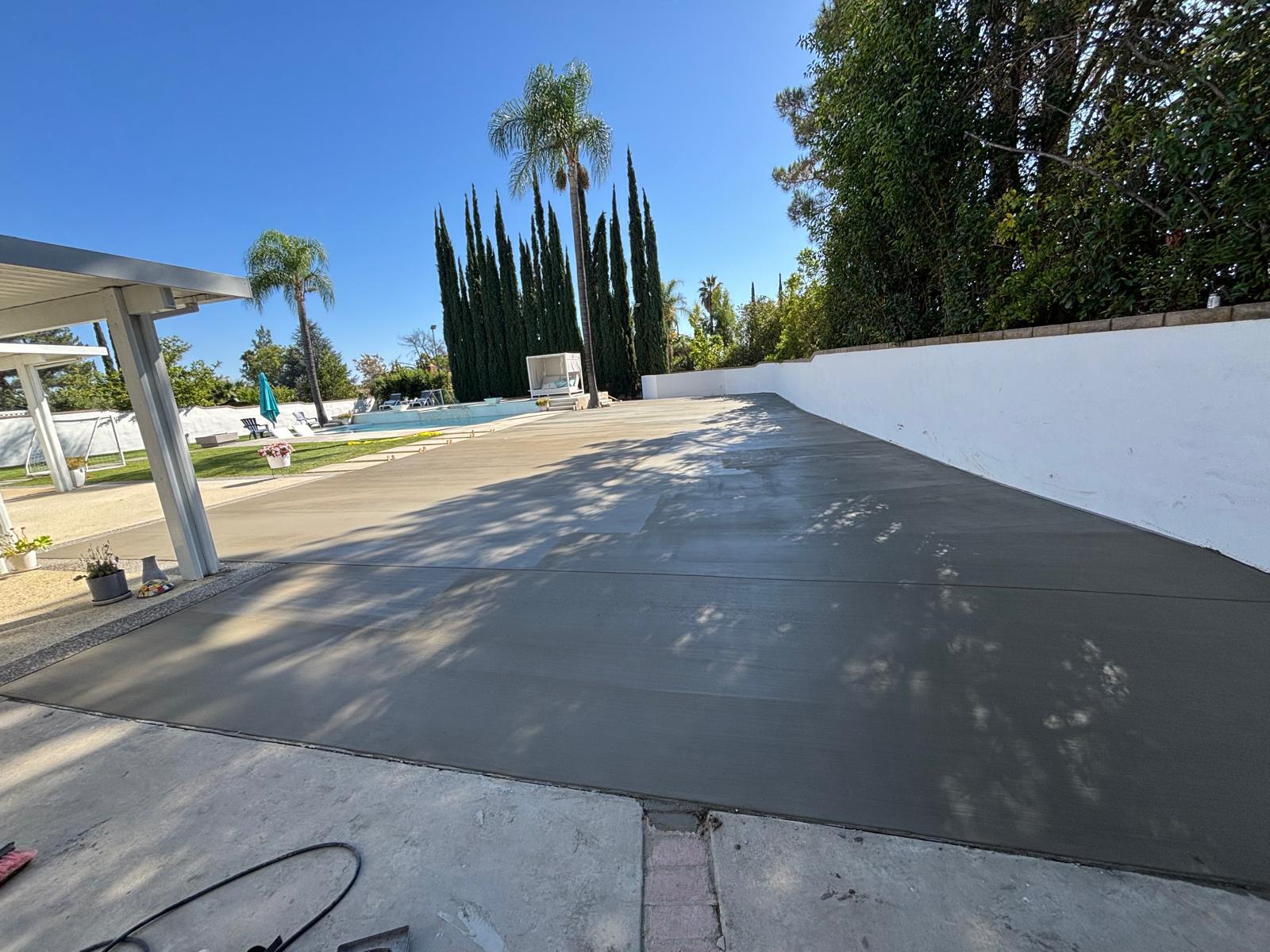 Freshly finished concrete pool deck by Alderete Concrete